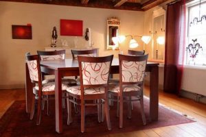 Warm wooden dining room in classic style.